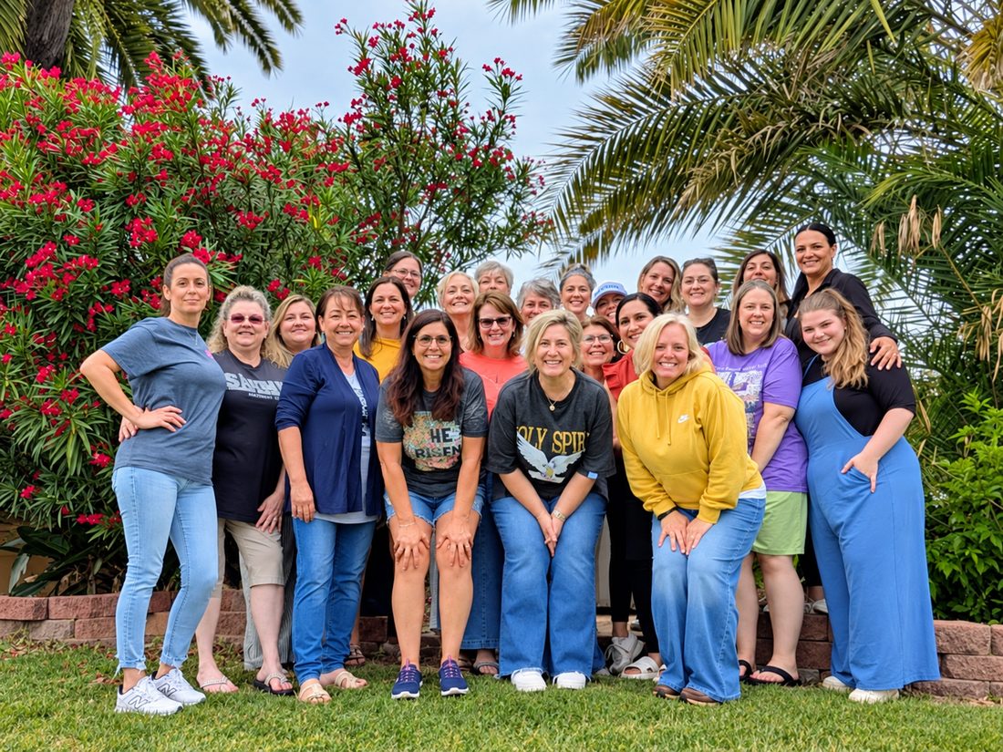 A large group of women gathered outdoors with the Royally Redeemed team