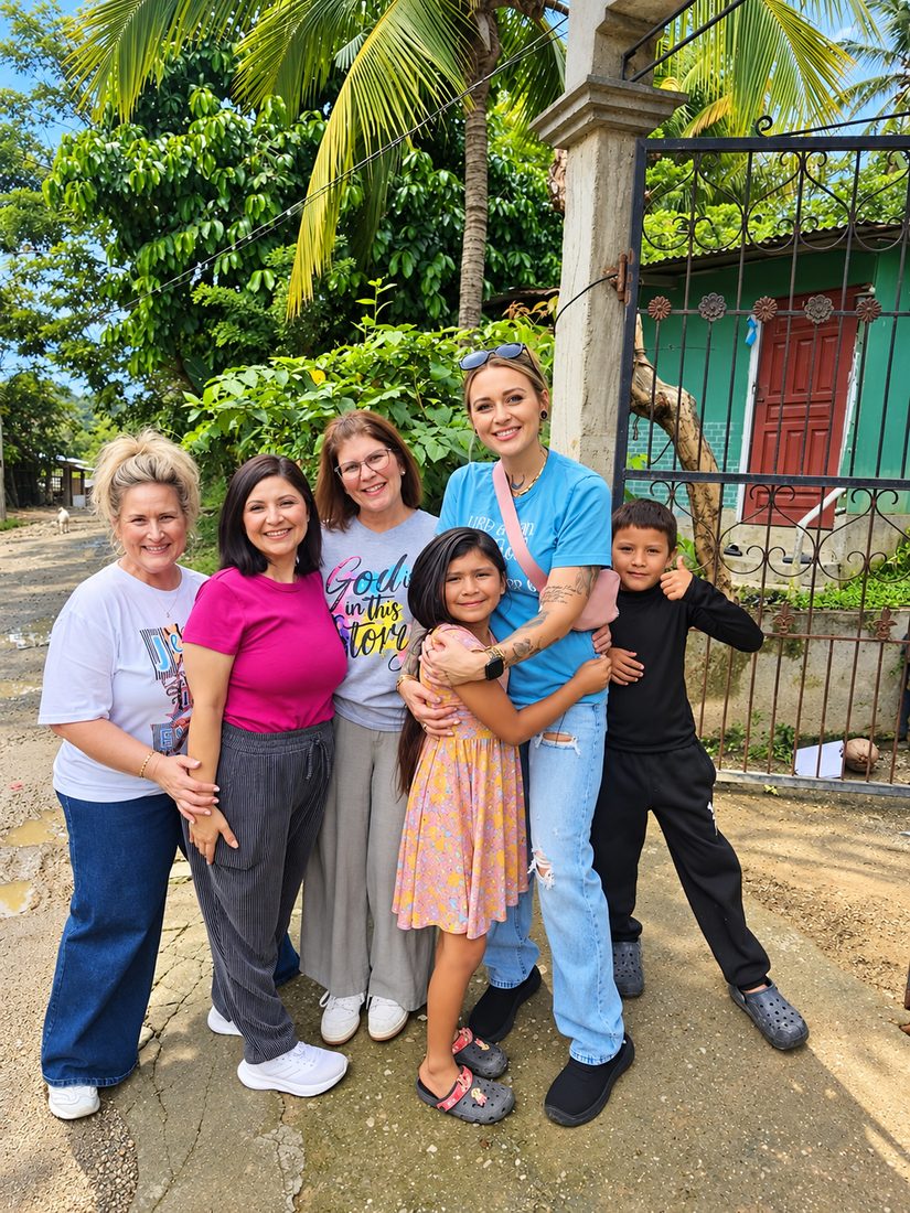 Royally Redeemed team members with children on a mission trip
