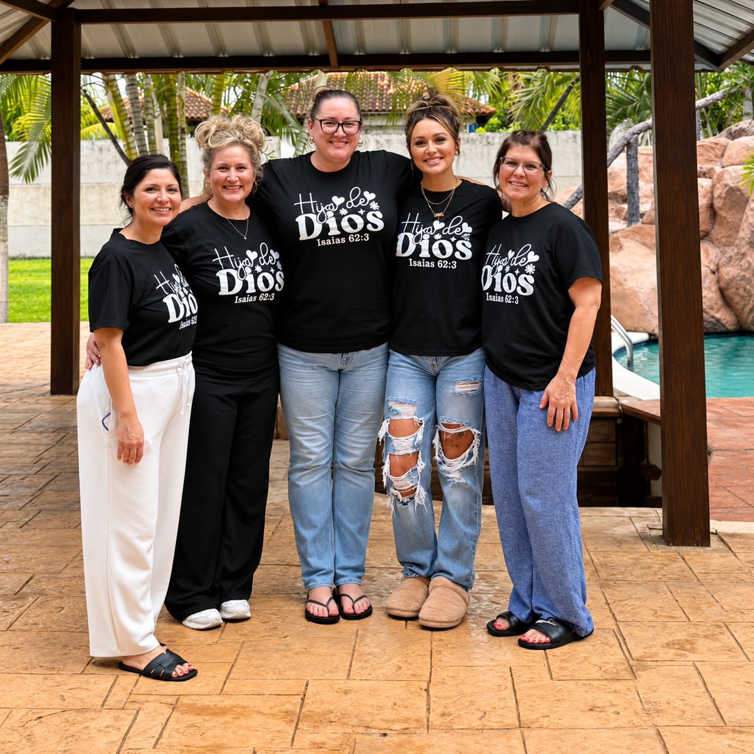 Five team members in Hija de Dios shirts on a mission trip